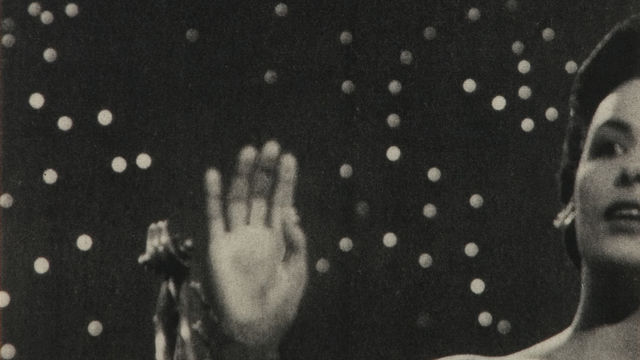 A black-and-white image of half a woman's face against a starry background