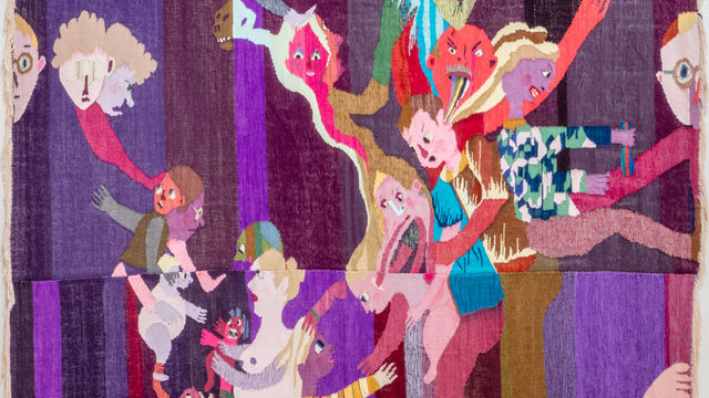 A purple tapestry of cartoonish, scary figures