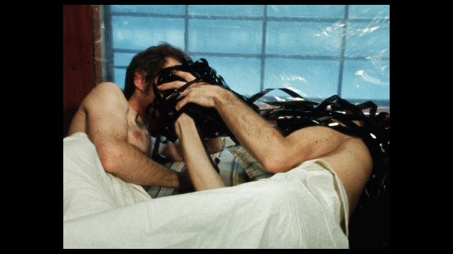 Still from the film "Blackstar: Autobiography of a Close Friend" (1977) showing two people partly under a sheet in bed