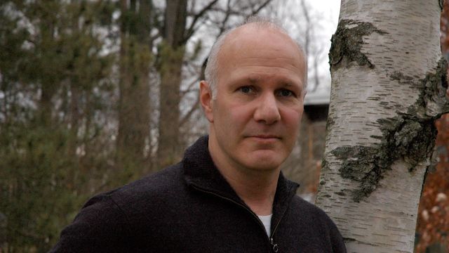 Headshot of man in a forest.