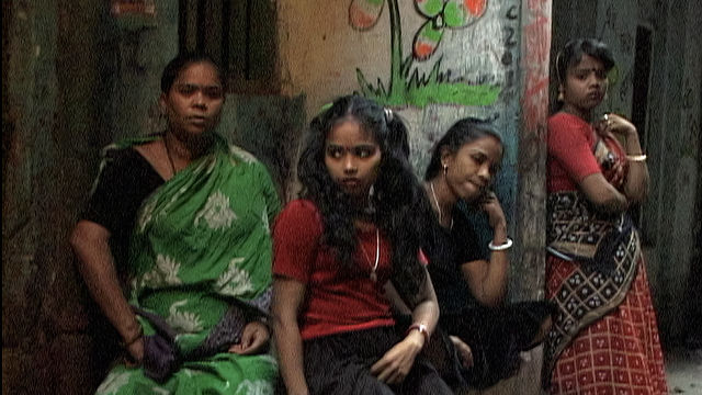 An Indian family stands on a street.