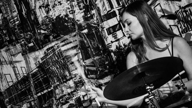 Woman playing the drums.