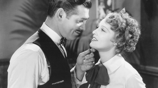 A woman and a man look tenderly at each other.