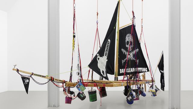 A pirate ship with various buckets and objects attached to it.