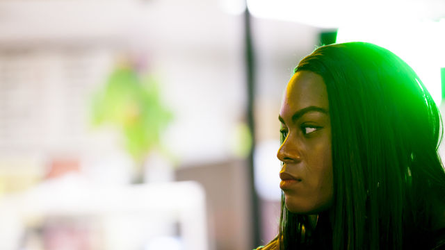 A woman stares into the distance.