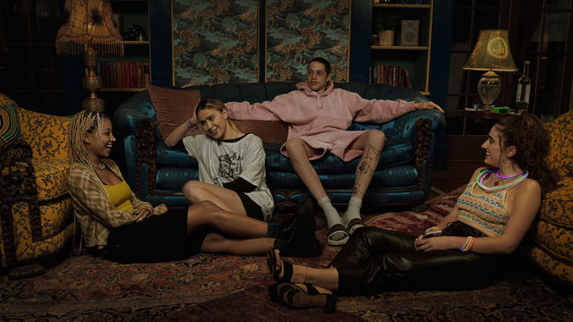 Still from the film "Bodies Bodies Bodies" (2022), showing four twenty-somethings relaxing in a living room