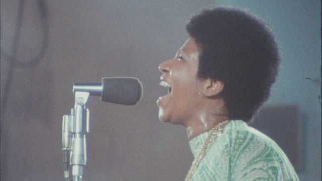 Aretha Franklin sings into microphone