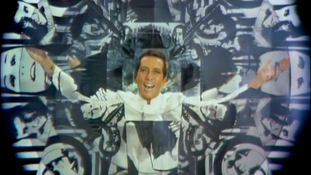 man smiles at camera through kaleidescope filter