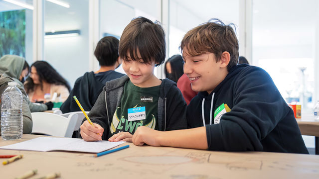 Two kids work on an art activity