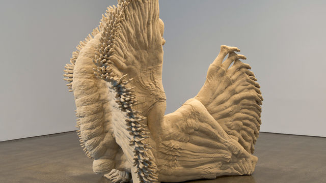 Sculpture of a female figure with arms and legs outstretched and multiplied into thousands