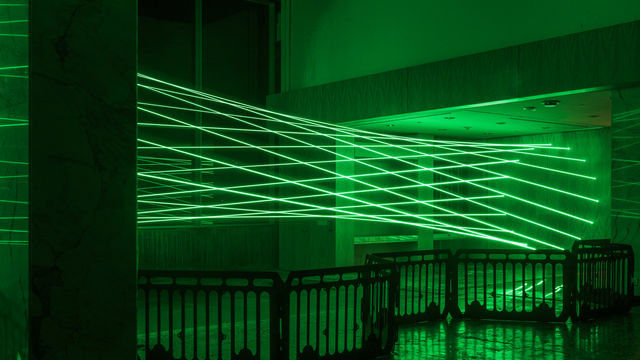 Green lasers fill a room