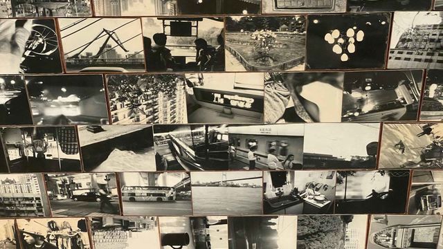 Installation on floor of black and white photographs