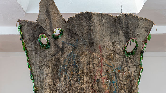 Large hanging artwork made from found materials