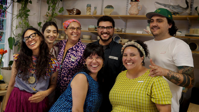 Photo of seven artists in a studio