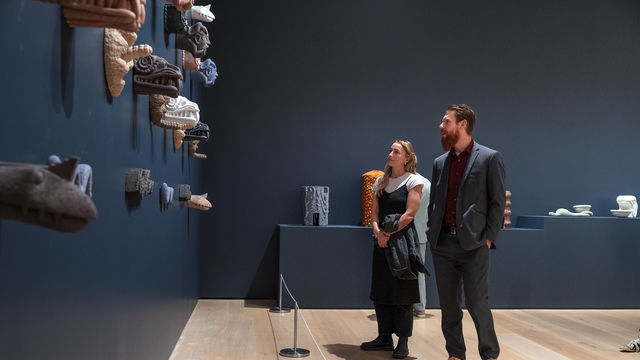 Two people looking at art in a gallery