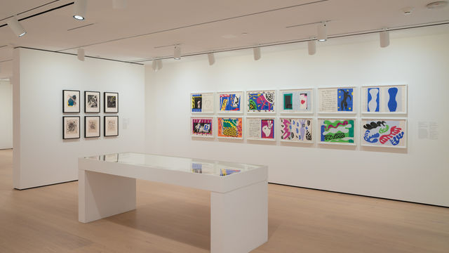 installation image of works on paper framed on walls