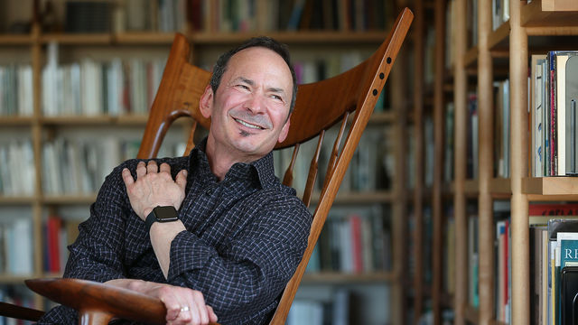 Forrest Gander, sitting in a rocking chair