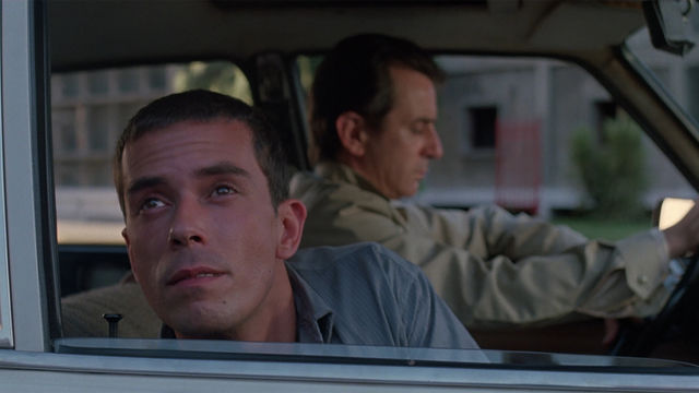 Close-up of a man looking out a car window