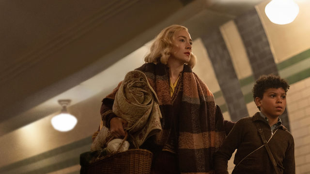 Saoirse Ronan & Elliott Heffernan walk together, holding a picnic basket and blanket