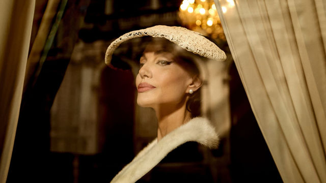 A fashionable woman wearing a hat and a black dress