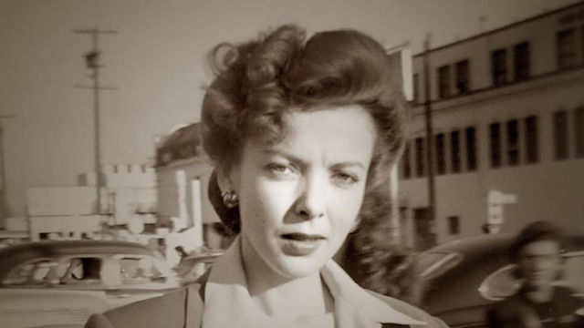 Ida Lupino looks at the camera