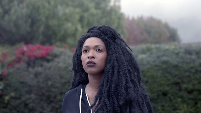 Film still of a Black woman with braids