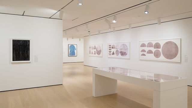 Installation view of framed works installed on wall