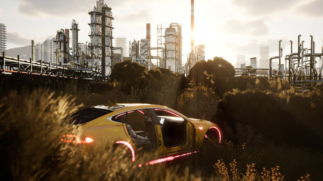 A dismantled yellow sportscar sits in a field