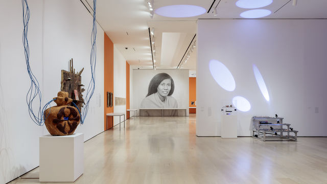 Installation view of a gallery with a large-scale photograph of Alice Coltrane