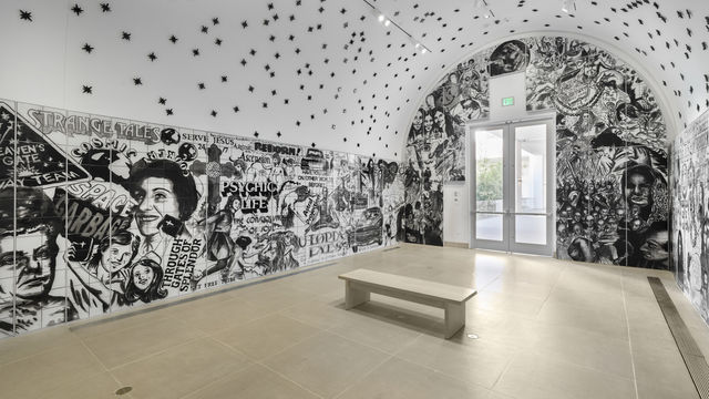 Vault installation featuring a floor-to-ceiling ceramic mural with black-and-white graphics, text, and images of people