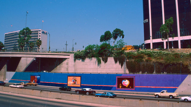 Archival image of a large-scale mural painted on the side of a freeway