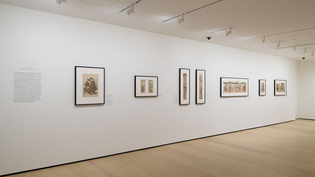 Gallery with framed works on paper installed on walls