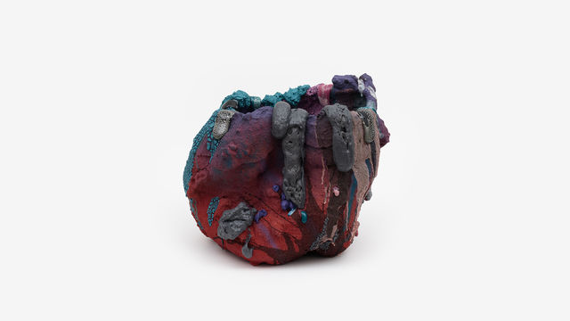 Abstract sculpture in reds, blues, browns, black, and grays