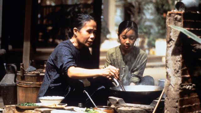 mother and daughter cooking outside