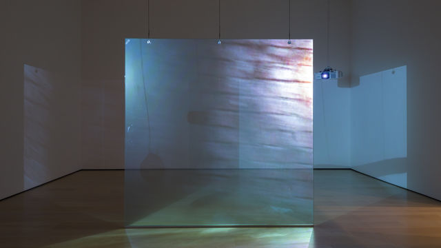 Video installation with images being projected on either side of a floating screen