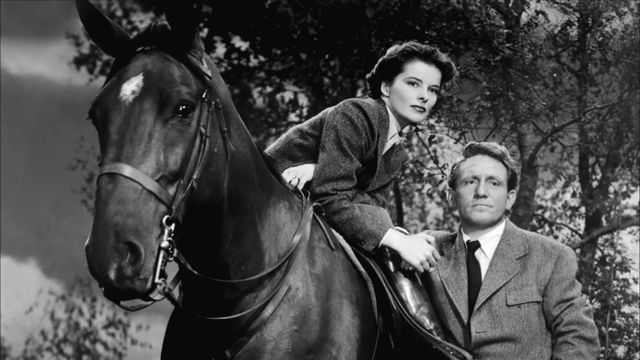 Katherine Hepburn, on a horse, next to Spencer Tracy