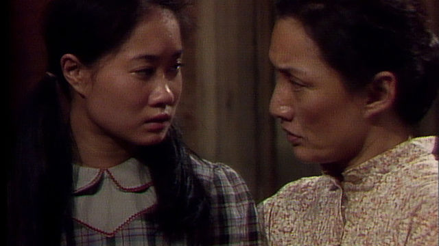 A woman and girl look at each other