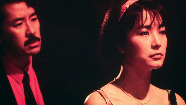 A woman turns her back to a man in a suit