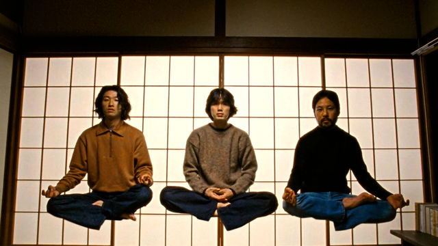 Three figures levitating while sitting cross-legged