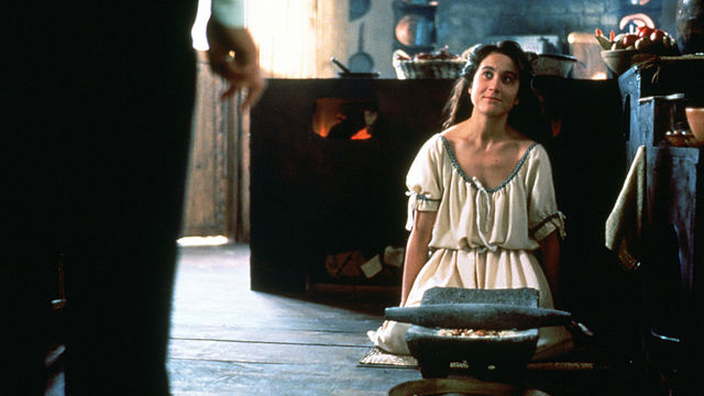 A woman kneels on the floor