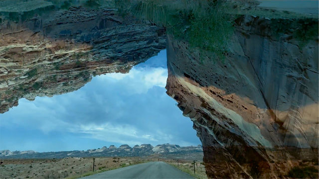A composite landscape with a remote highway and a large rock formation