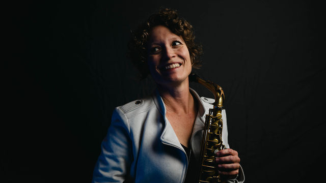 Kasey Knudsen holding a saxophone