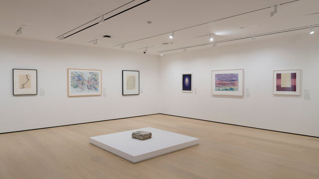 Gallery with works on paper installed on the wall and on a plinth