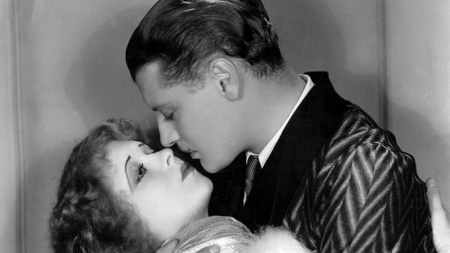Black and white image of a man and woman embracing