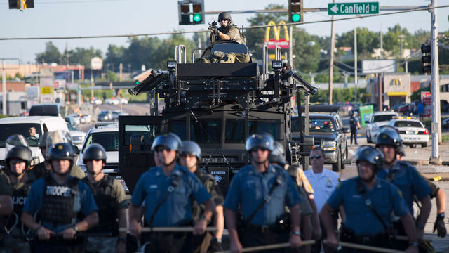 RIOT POLICE STAND GUARD DURING PROTESTS OF THE 2014 SHOOTING DEATH OF MICHAEL BROWN IN FERGUSON, MISSOURI. PHOTO: REUTERS/MARIO ANZUONI