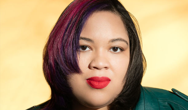 Portrait of a woman with a yellow background.