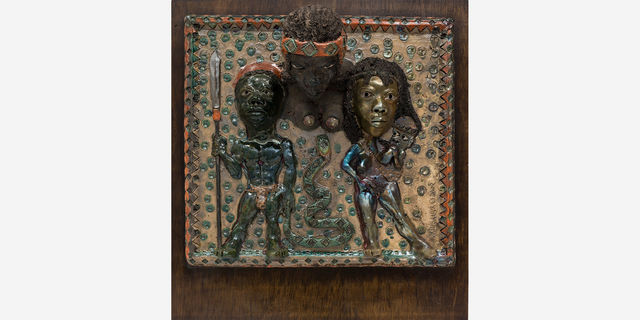 Dimensional sculpture with three figures in African garb