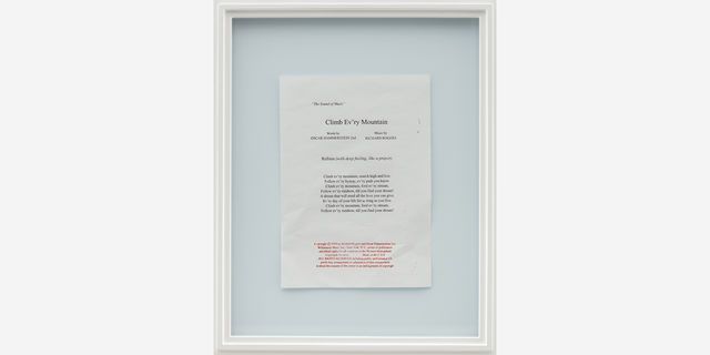 a framed piece of paper writing