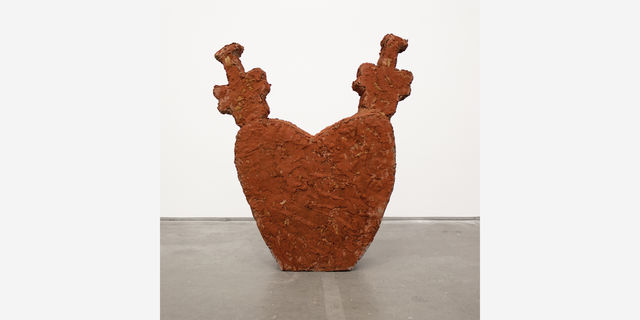 a cement sculpture in the shape of a heart