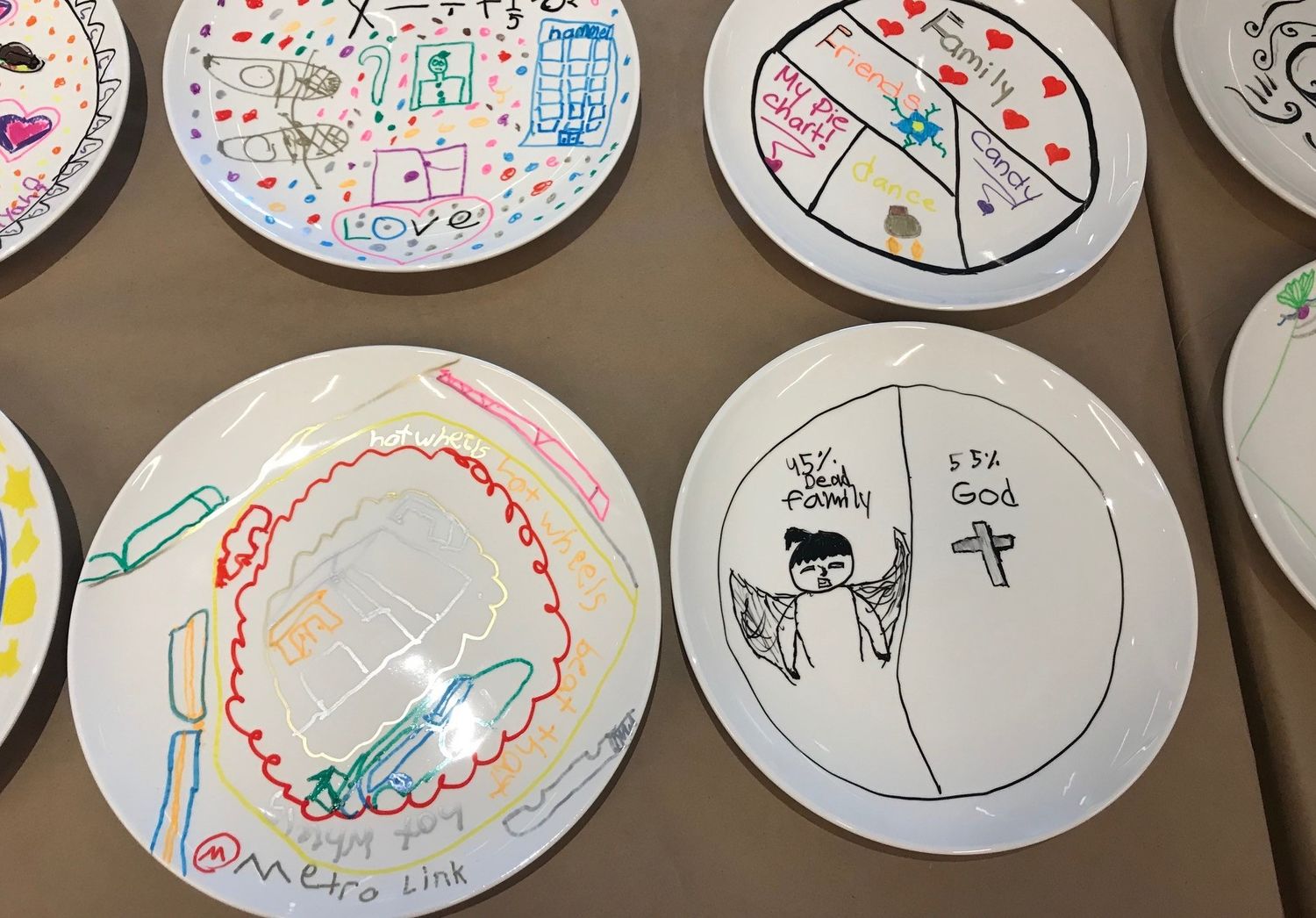 Several plates covered in children's drawings